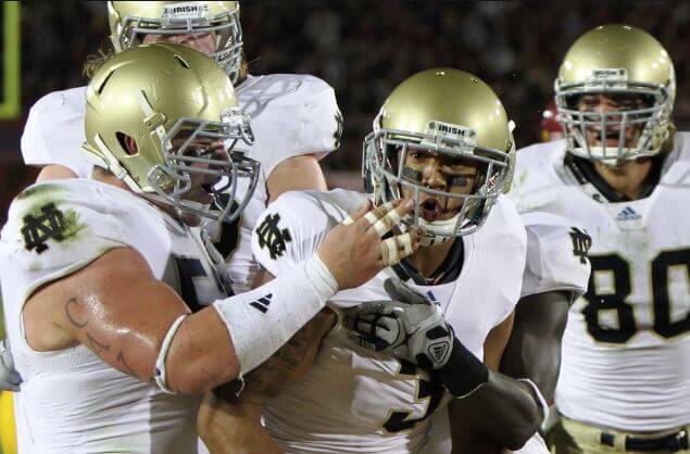 Notre Dame football players celebrating.