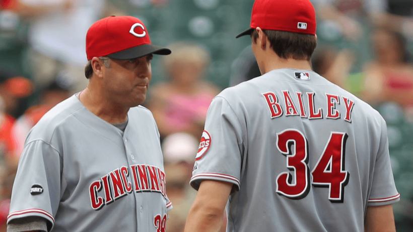 Bryan Price talks to Homer Bailey on the mound.