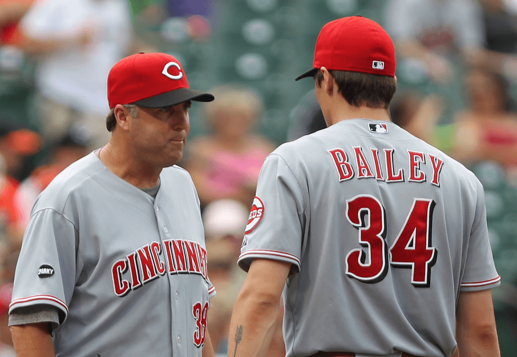 Bryan Price talks to Homer Bailey on the mound.