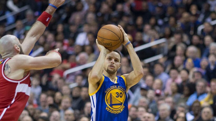 Steph Curry shooting from behind the arc.