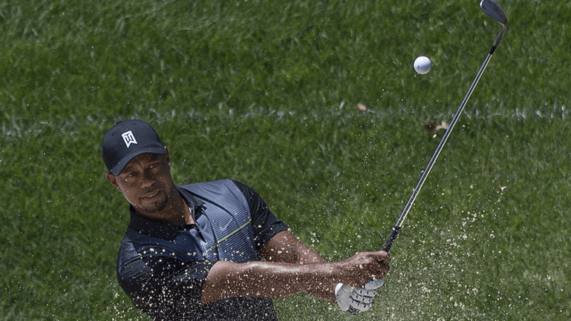 Tiger Woods chipping out of a bunker