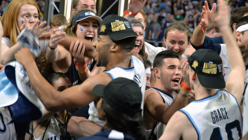 Phil Booth celebrating Villanova's 2018 national championship with fans and teammates.