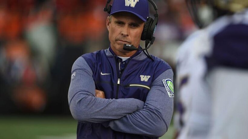Huskies head coach Chris Petersen scouring on the Washington sideline.