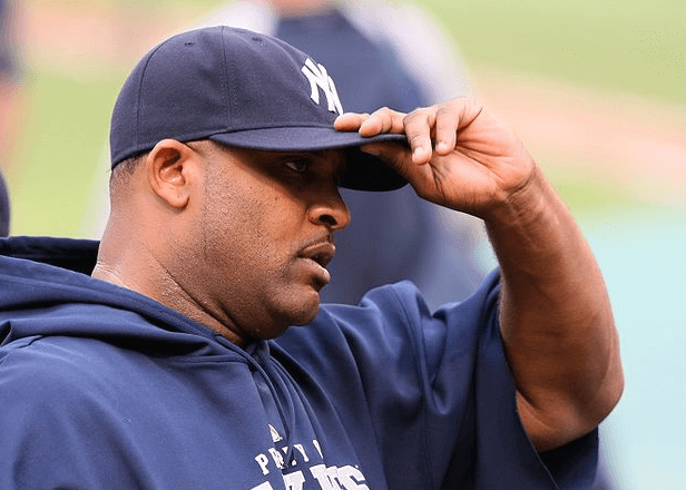 Yankees pitcher CC Sabathia adjusting his cap.