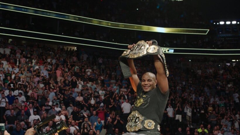 Daniel Cormier celebrates as the light heavyweight and heavyweight double champ