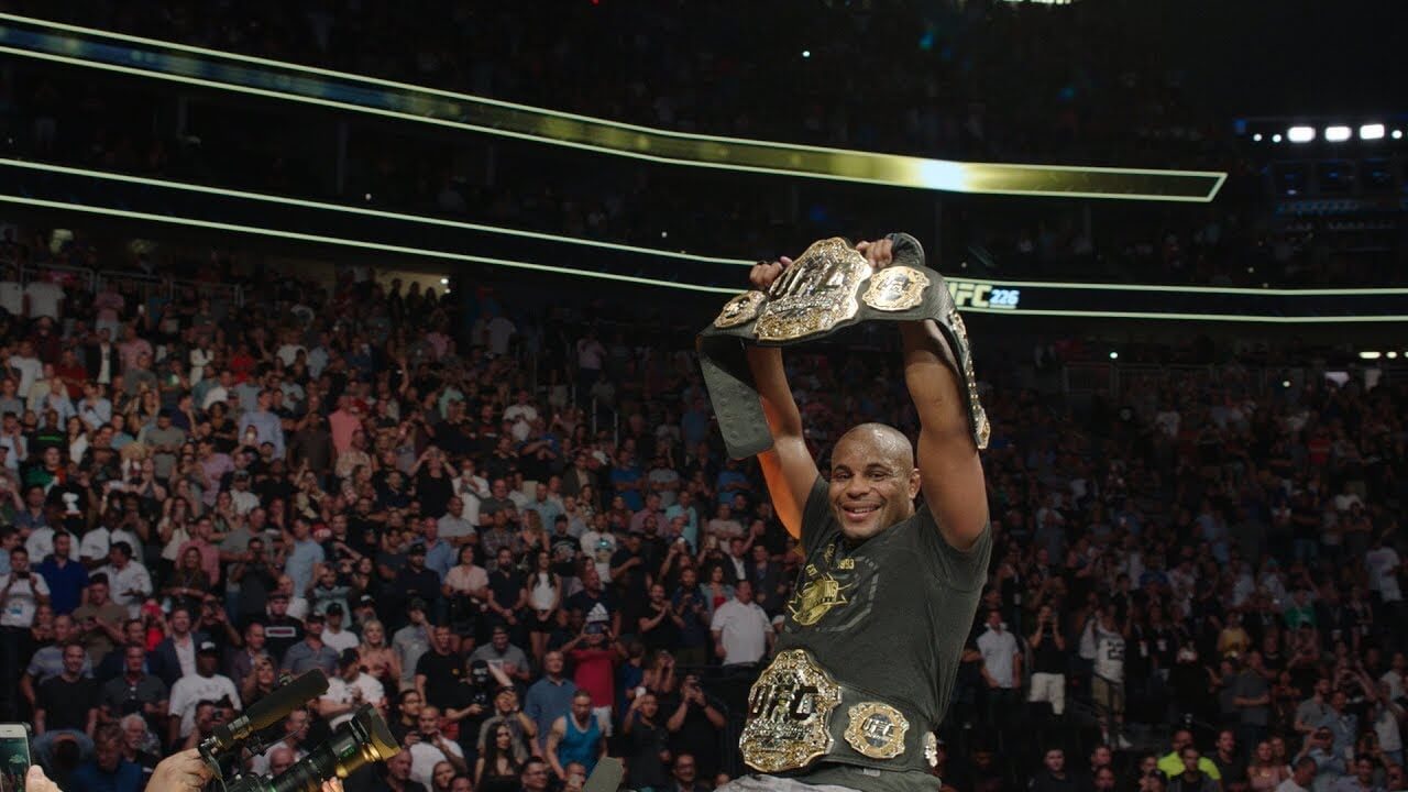 Daniel Cormier celebrates as the light heavyweight and heavyweight double champ