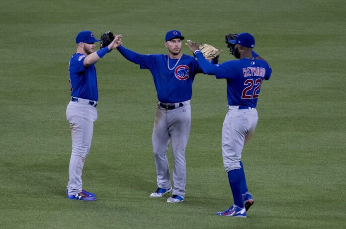 Chicago Cubs outfielders celebrating a win.