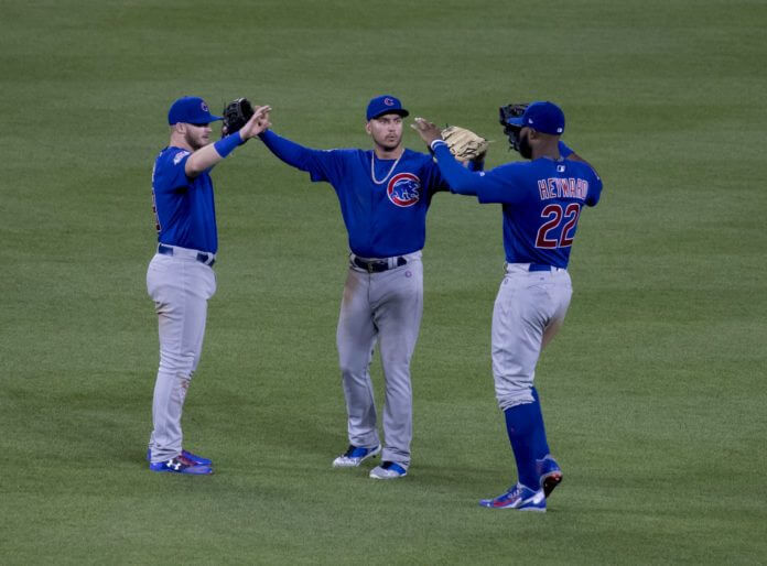 Chicago Cubs outfielders celebrating a win.