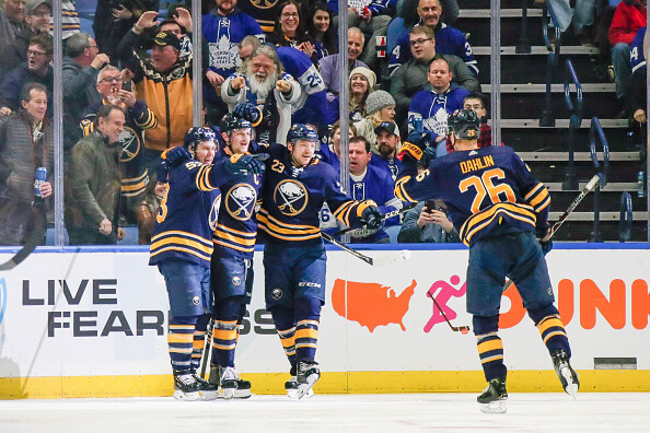 Sabres players celebrating a goal.