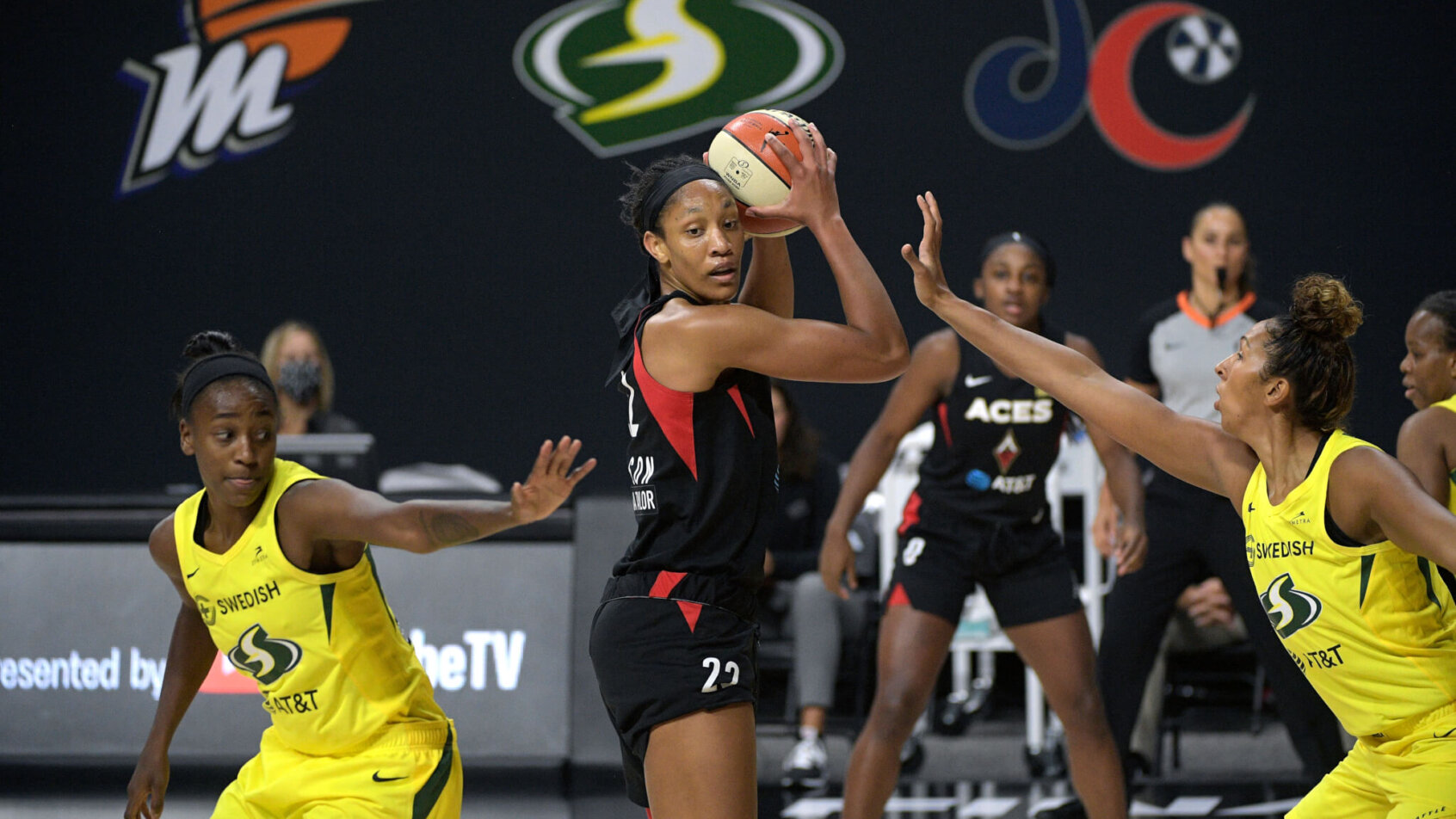 A'ja Wilson is defended by two Seattle players