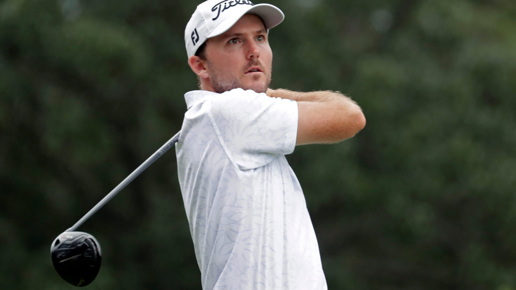 Russell Henley watching his drive