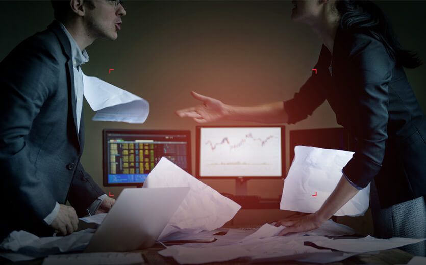 two professionals in an office arguing over documents