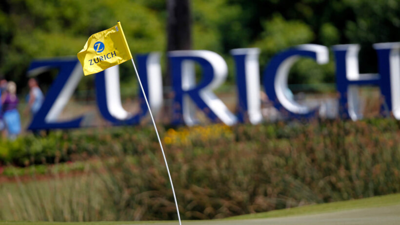 A flag at the 17th hole on the golf course swinging in the heavy winds.