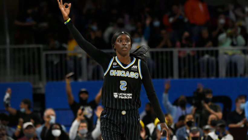 Kahleah Copper holds up three fingers after making shot