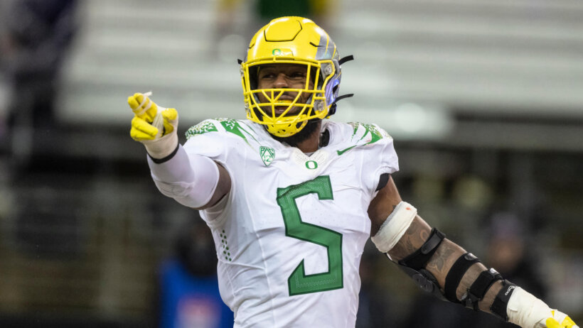 Kayvon Thibodeaux points towards the sidelines
