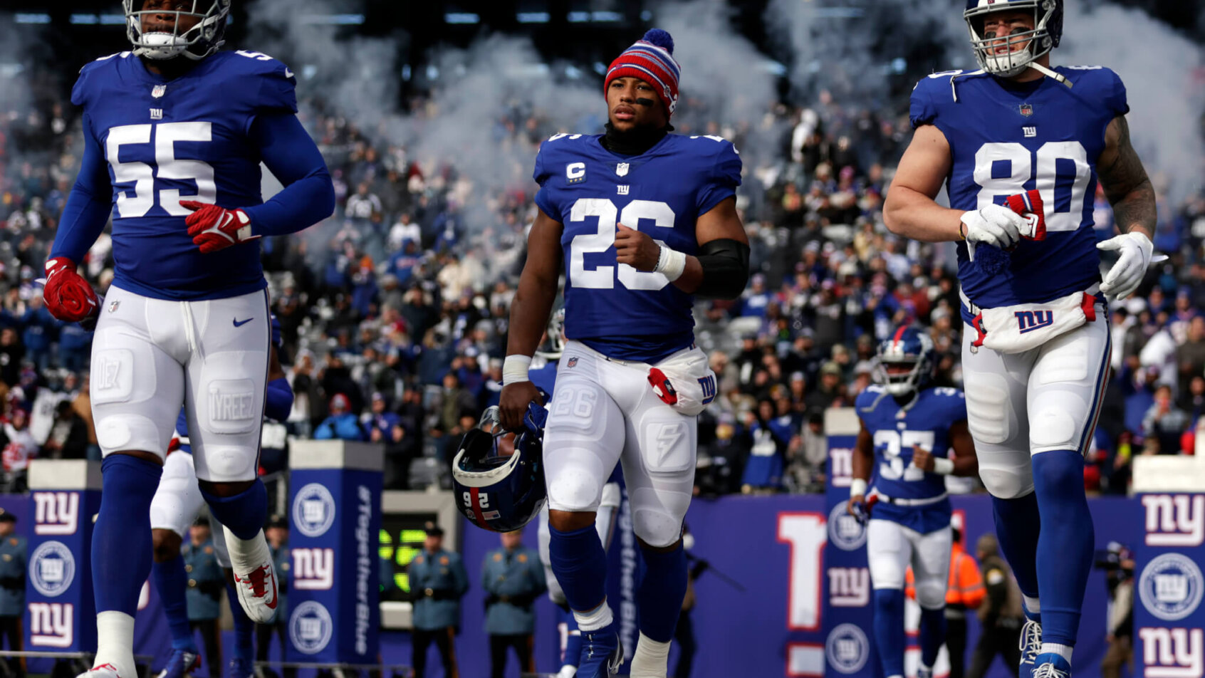 The Giants run onto the field