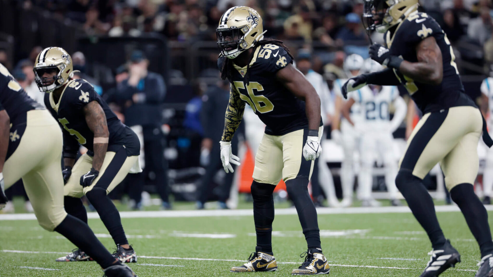 Saints players lined up on the field during an NFL football game.