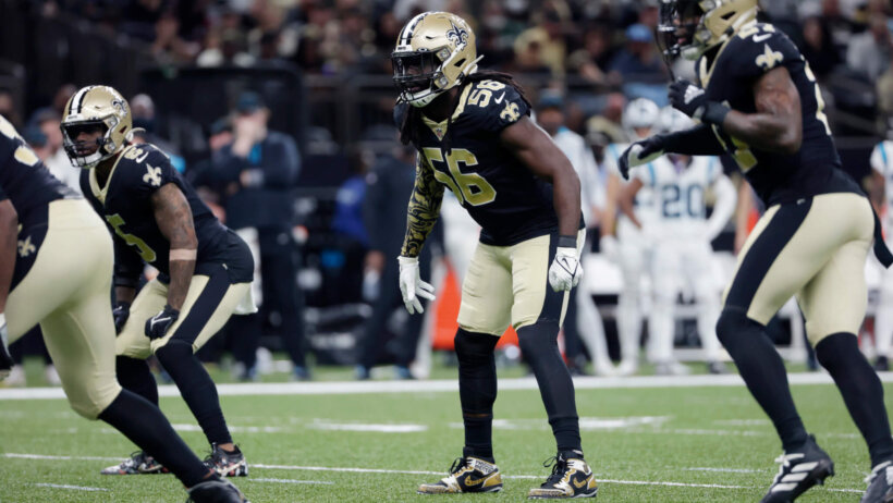 Saints players lined up on the field during an NFL football game.