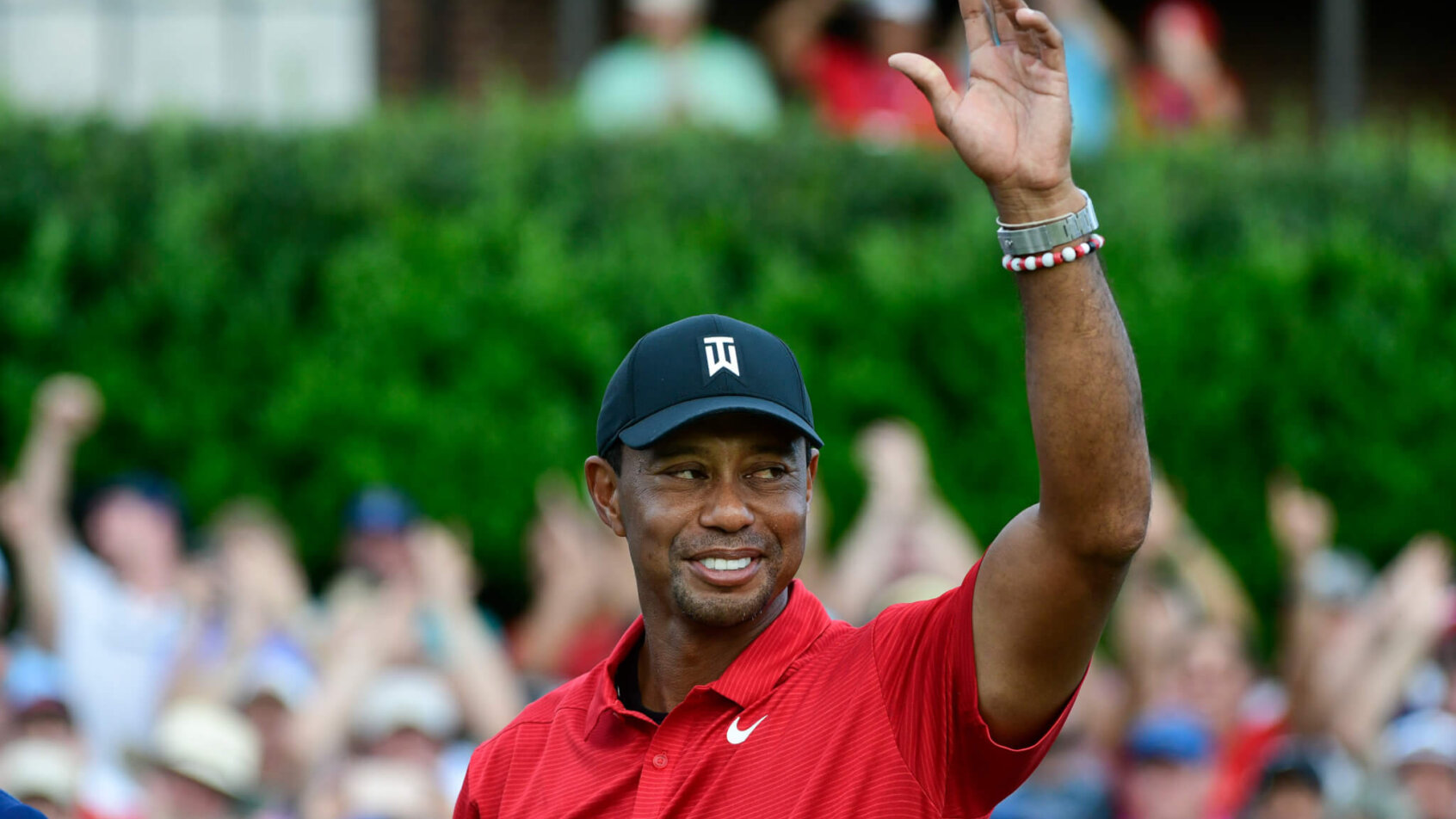 Tiger Woods waves