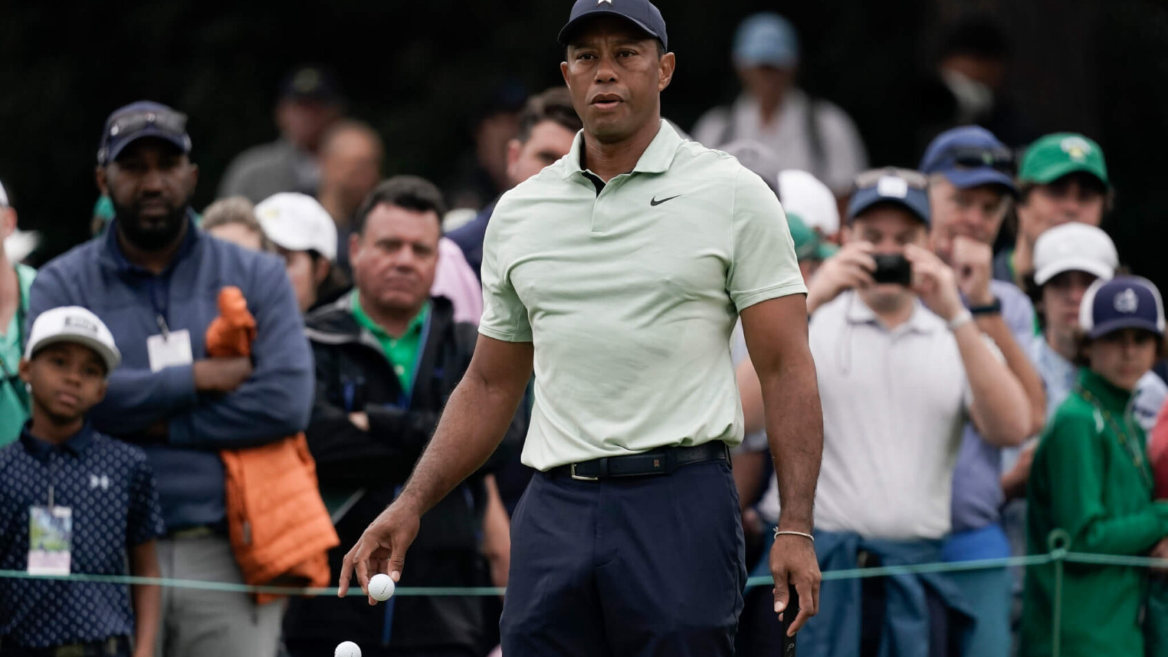 Tiger Woods watches a practice shot