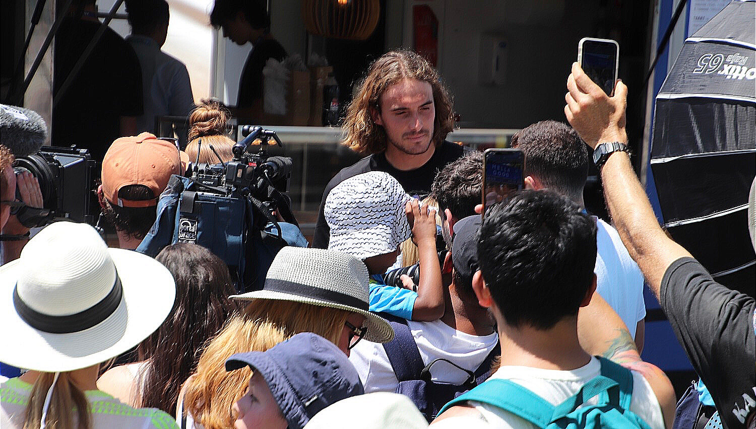 Stefanos Tsitsipas surrounded by fans