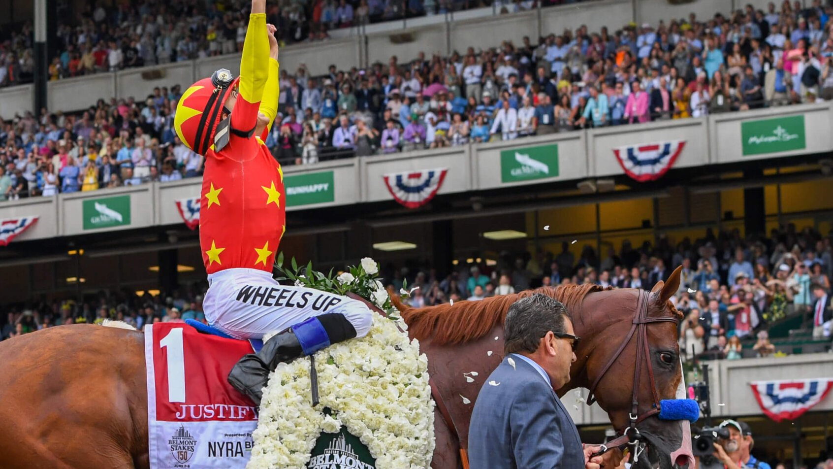 Mike Smith aboard Justify (1) celebrates the winning of the 150th running of the Belmont Stakes