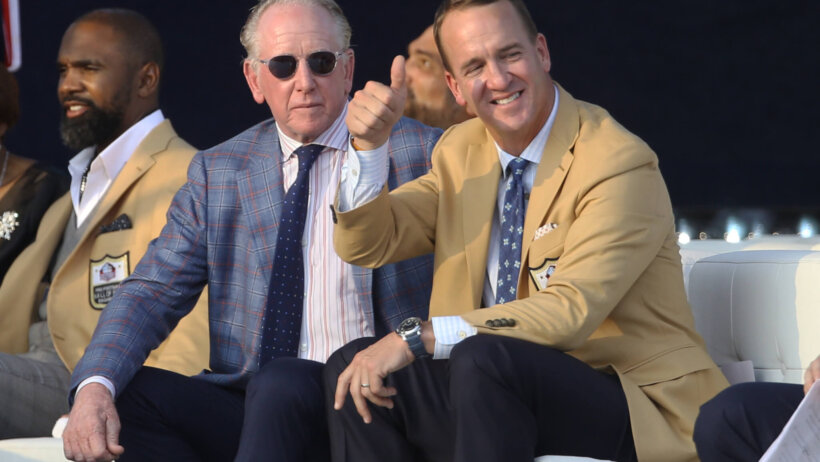Peyton Manning thumbs up beige suit Archie Manning sunglasses blue suit