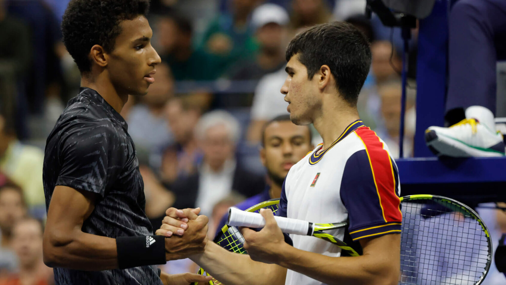Felix Auger-Alliassime of Canada (L) shakes hands with Carlos Alcaraz