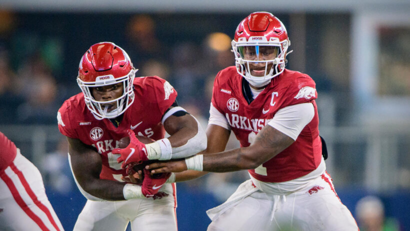 Arkansas Razorbacks quarterback KJ Jefferson hands off to running back Raheim Sanders