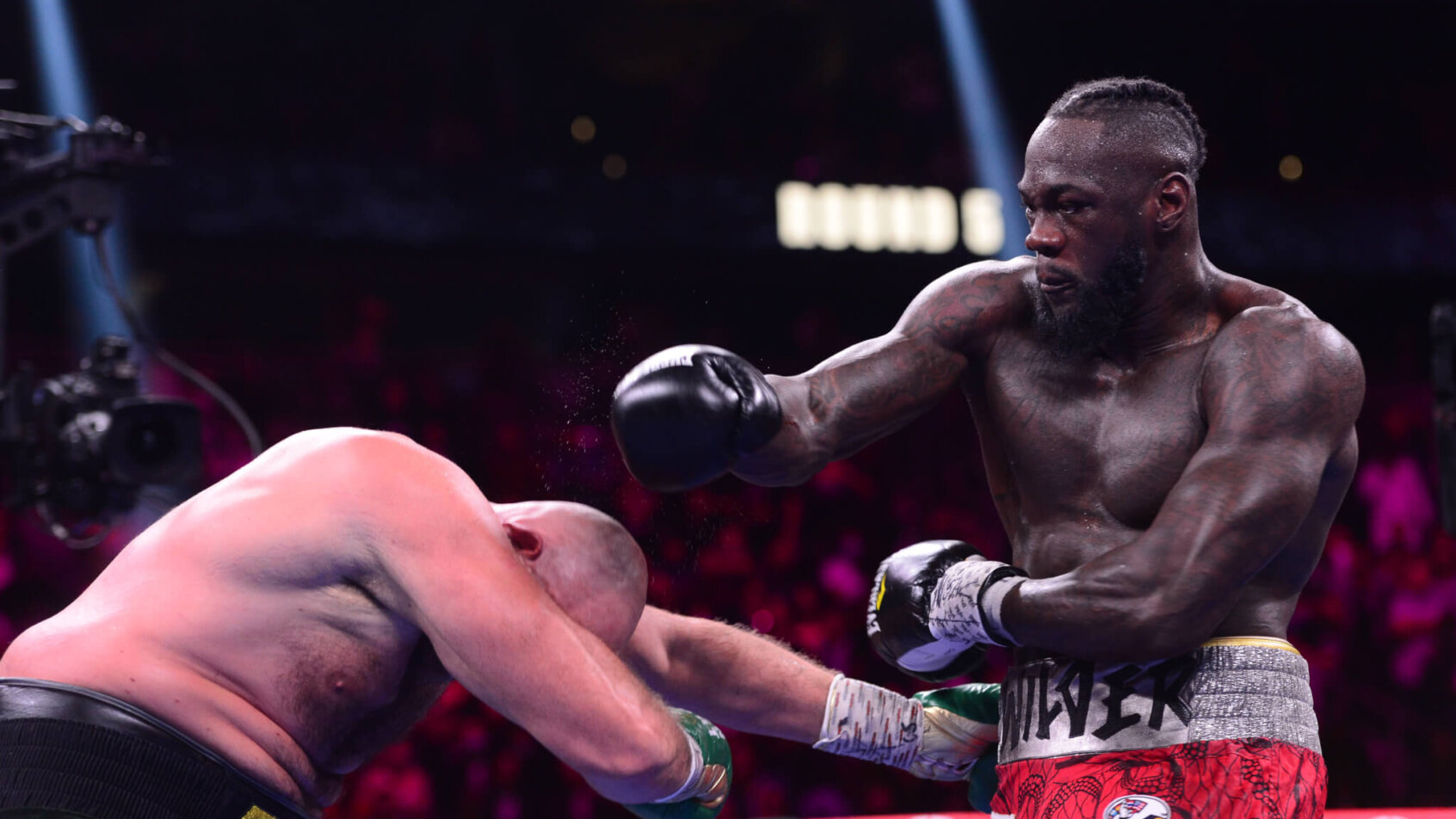Deontay Wilder lands a punch in the boxing ring