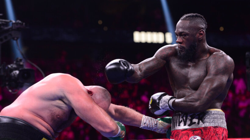 Deontay Wilder lands a punch in the boxing ring
