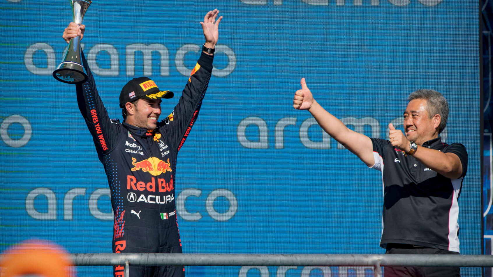 Red Bull Racing Honda driver Sergio Perez celebrating a podium finish