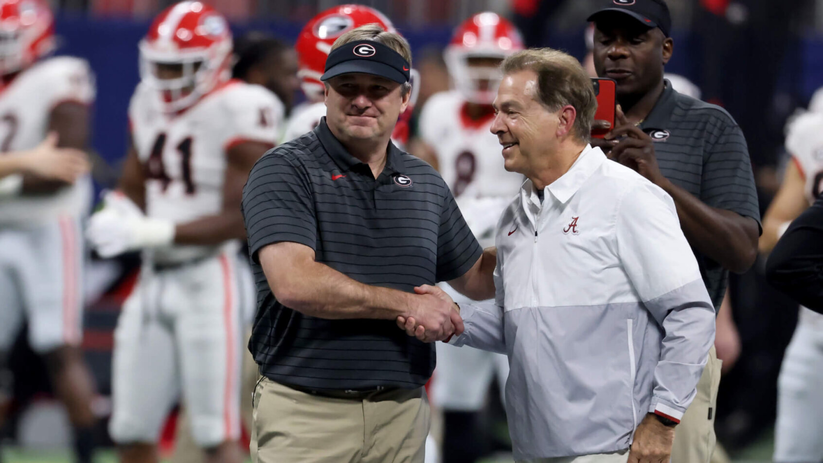 Georgia Bulldogs head coach Kirby Smart greets Alabama Crimson Tide head coach Nick Saban before the SEC championship game at Mercedes-Benz Stadium