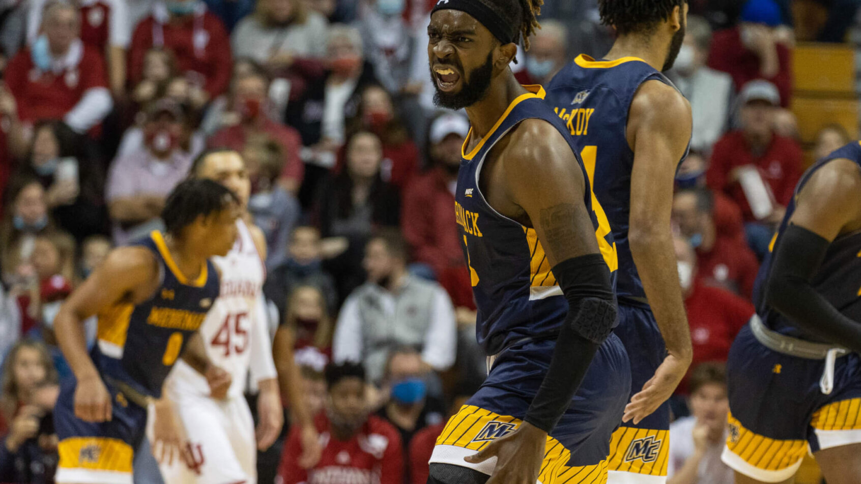 Merrimack Warriors guard Ziggy Reid celebrates a basket