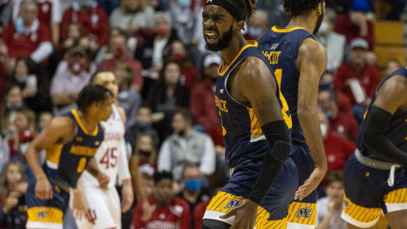 Merrimack Warriors guard Ziggy Reid celebrates a basket