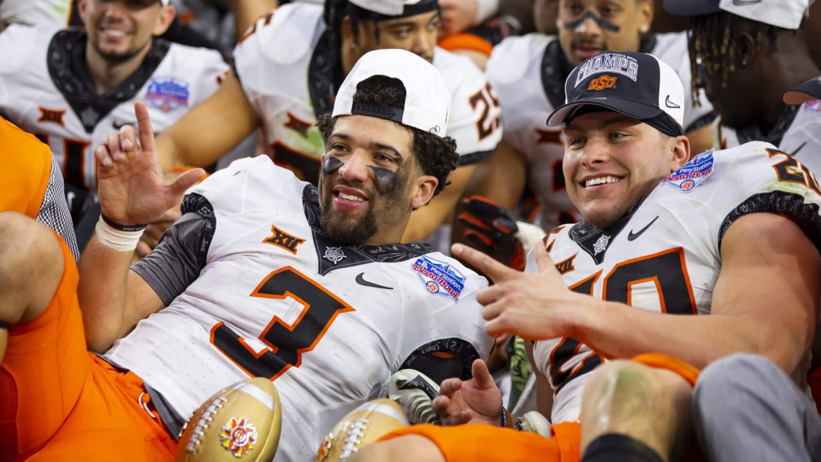Oklahoma State Cowboys quarterback Spencer Sanders and linebacker Malcolm Rodriguez celebrate winning the Fiesta Bowl over Notre Dame