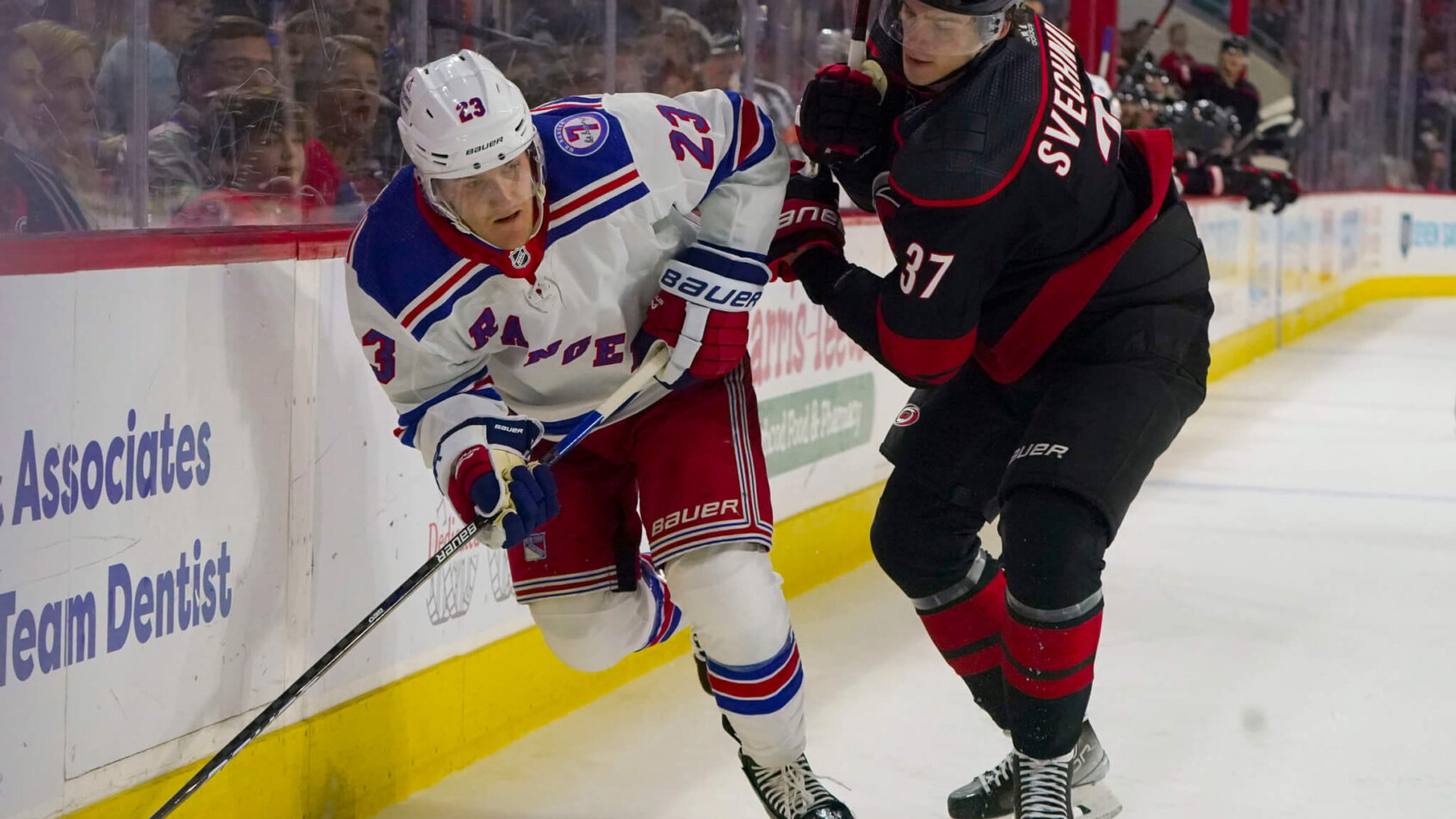 New York Rangers defenseman Adam Fox carries the puck along the boards