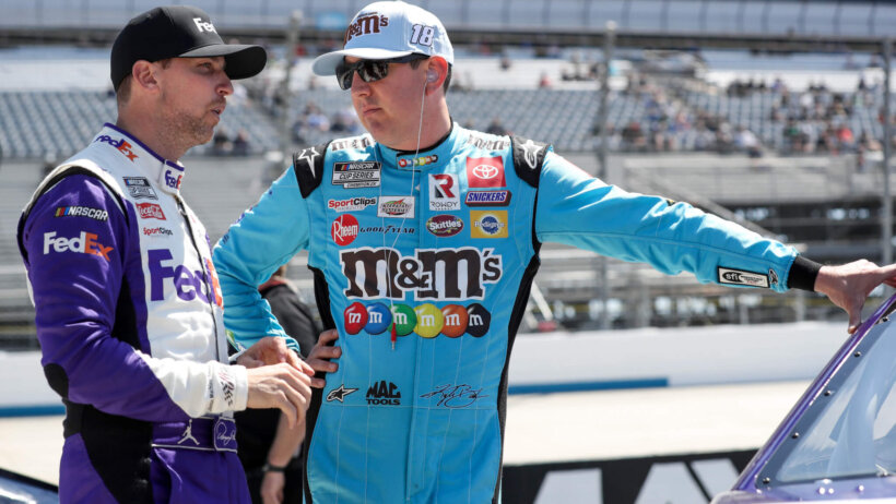 NASCAR Cup Series drivers Kyle Busch and Denny Hamlin talking on pit road