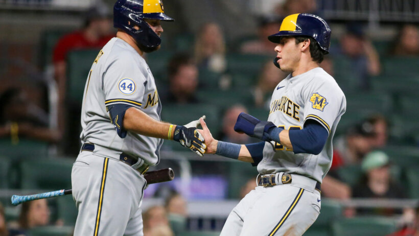 Milwaukee Brewers left fielder Christian Yelich celebrating a run with catcher Rowdy Tellez