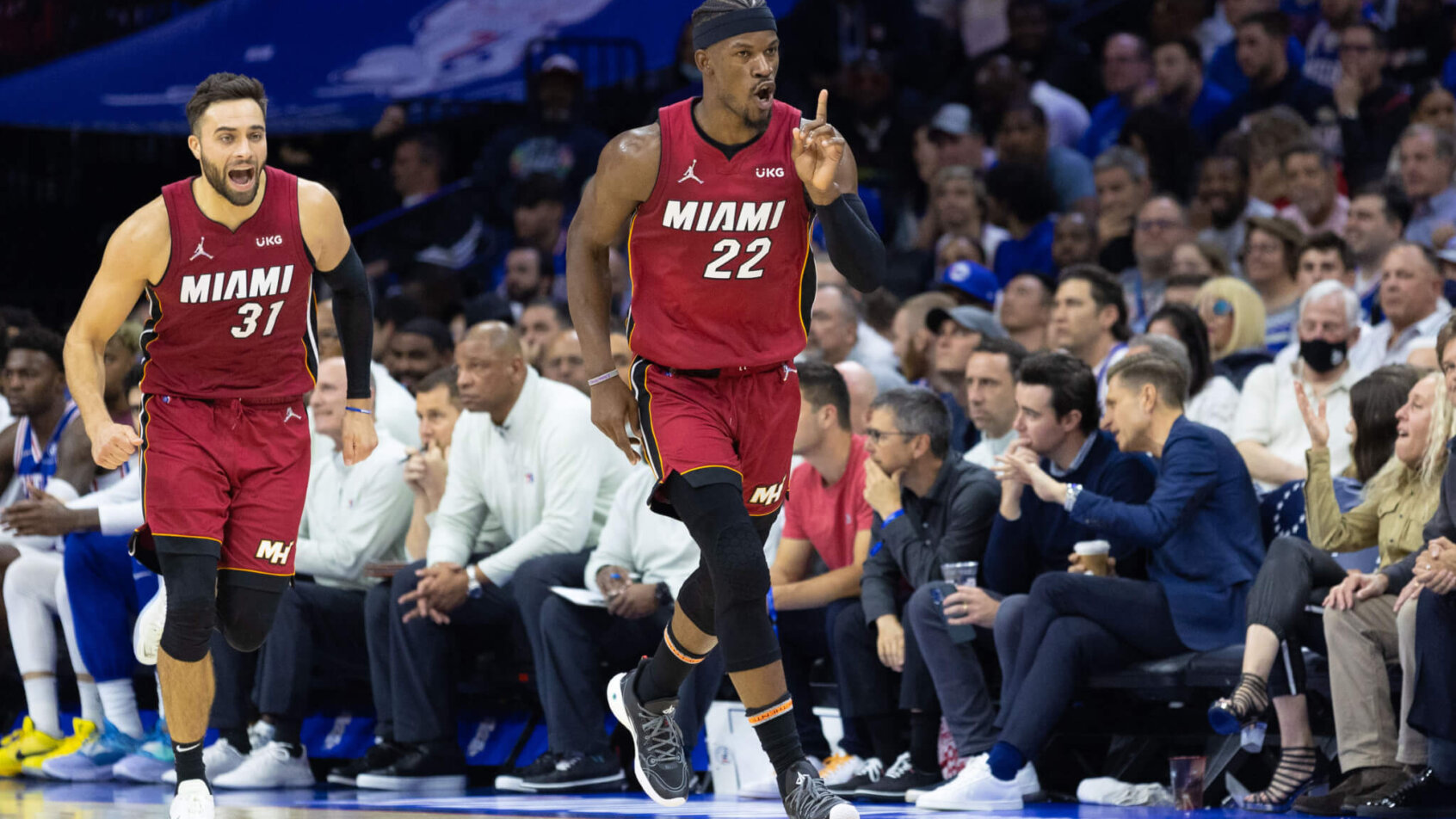 Jimmy Butler running down the court holding up 1 finger