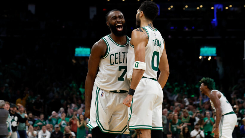 Jaylen Brown and Jayson Tatum celebrating on the court