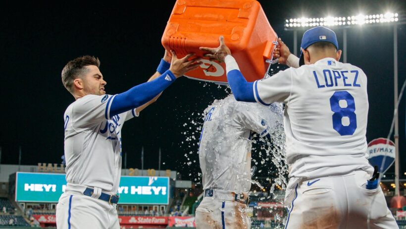 Kansas City Royals Whit Merrifield and Nicky Lopez dumping water on Bobby Witt Jr