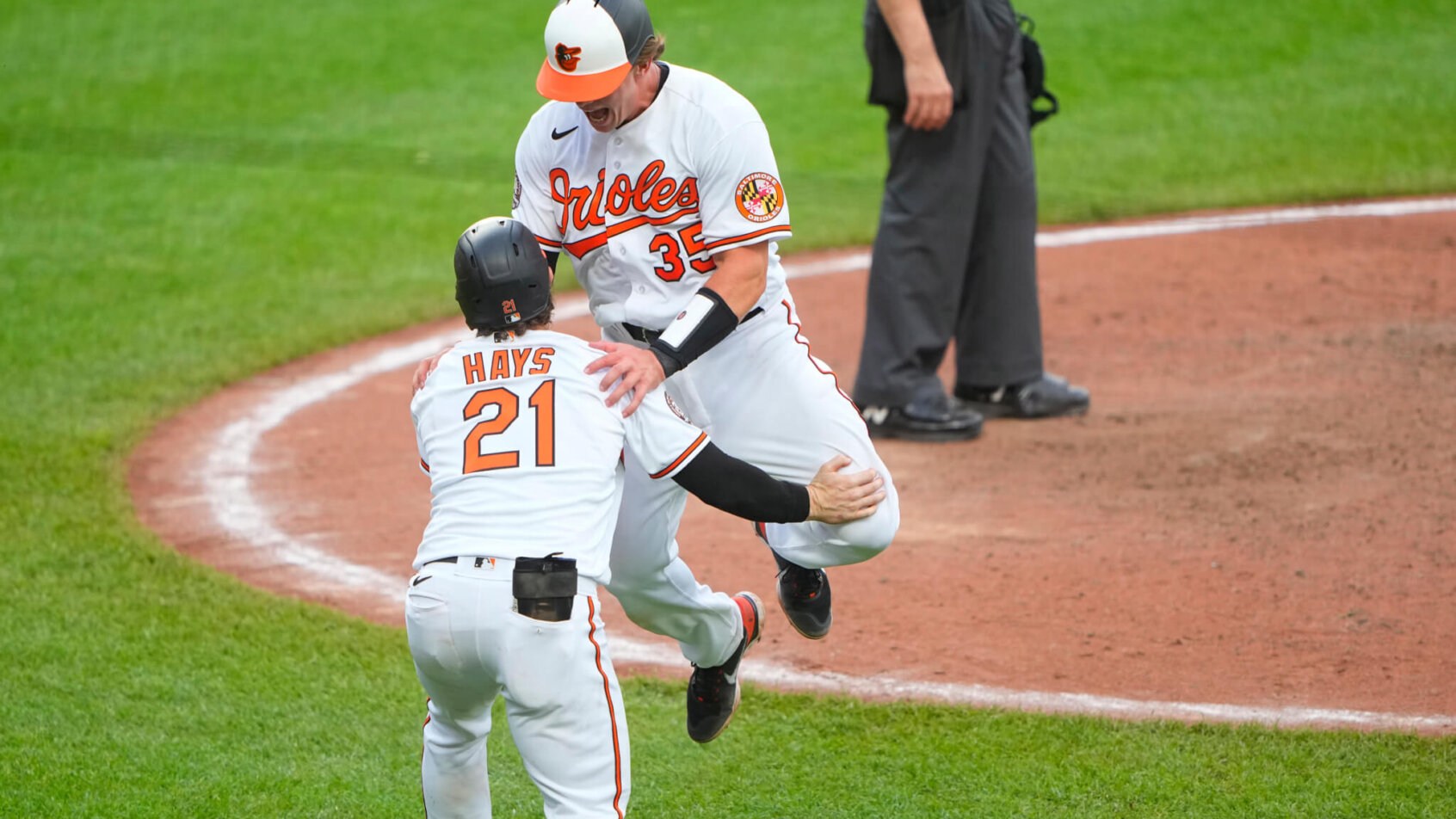 Baltimore Orioles designated hitter Adley Rutschman celebrating with left fielder Austin Hays after scoring a walk-off run