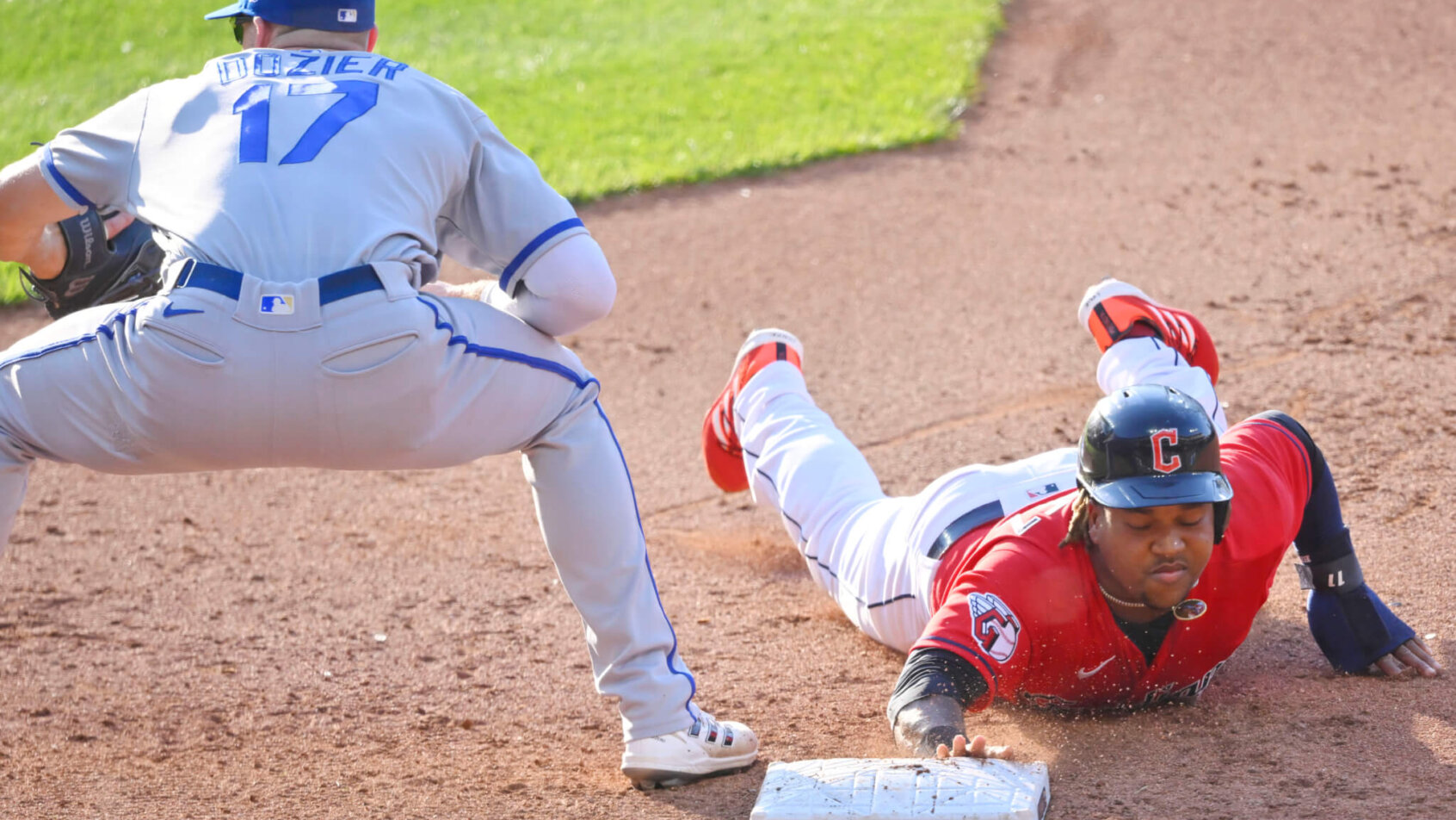 Cleveland Guardians designated hitter Jose Ramirez diving back into first base