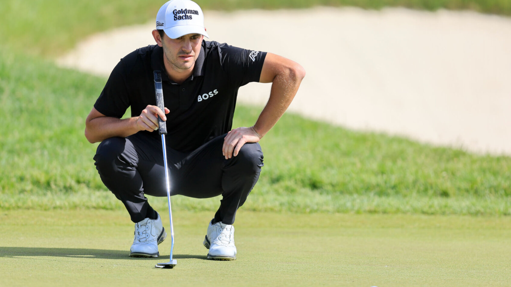 Patrick Cantlay lines up a putt