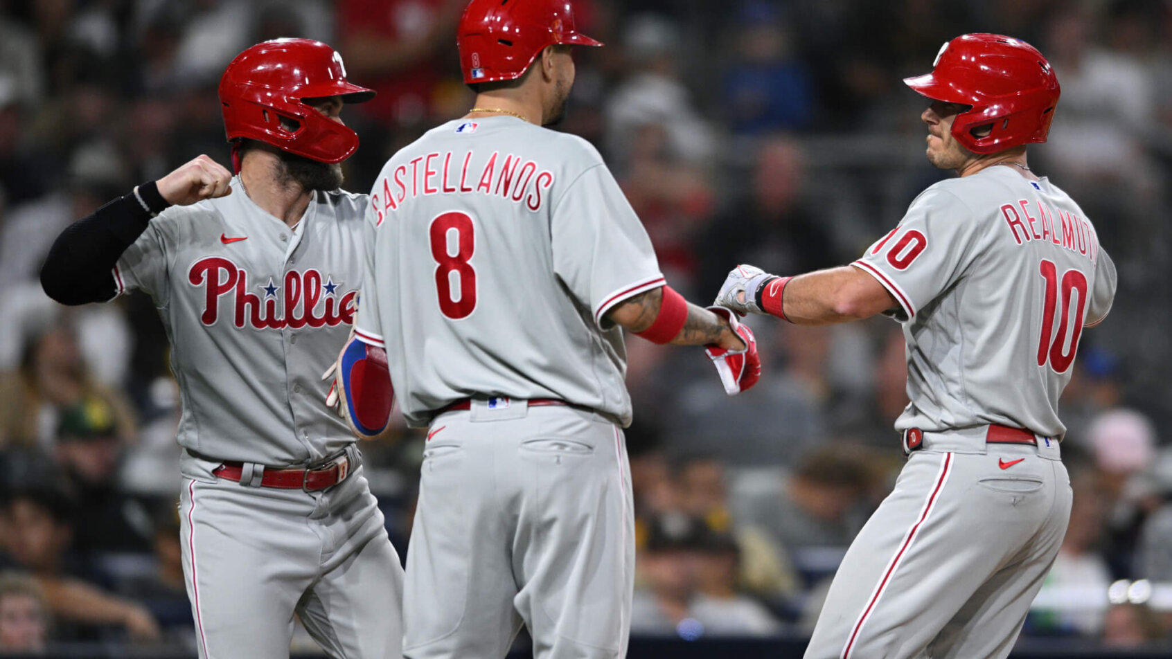 Phillies players celebrate after JT Realmuto hits a home run.