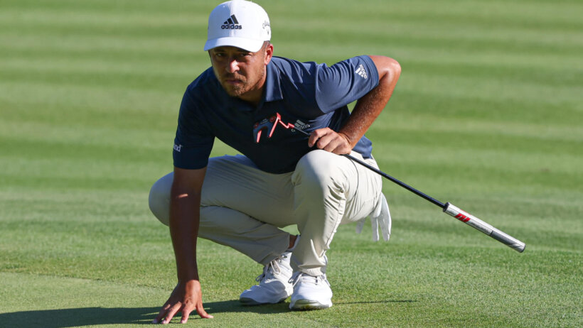 Xander Schauffele looks over a putt