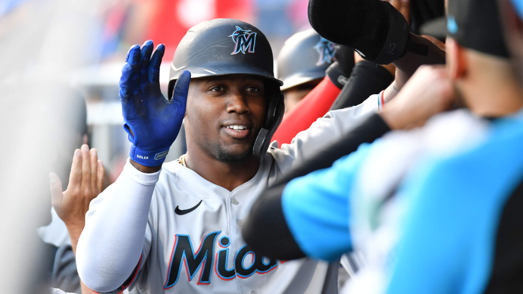 Jorge Soler high-fiving Miami teammates after a home run