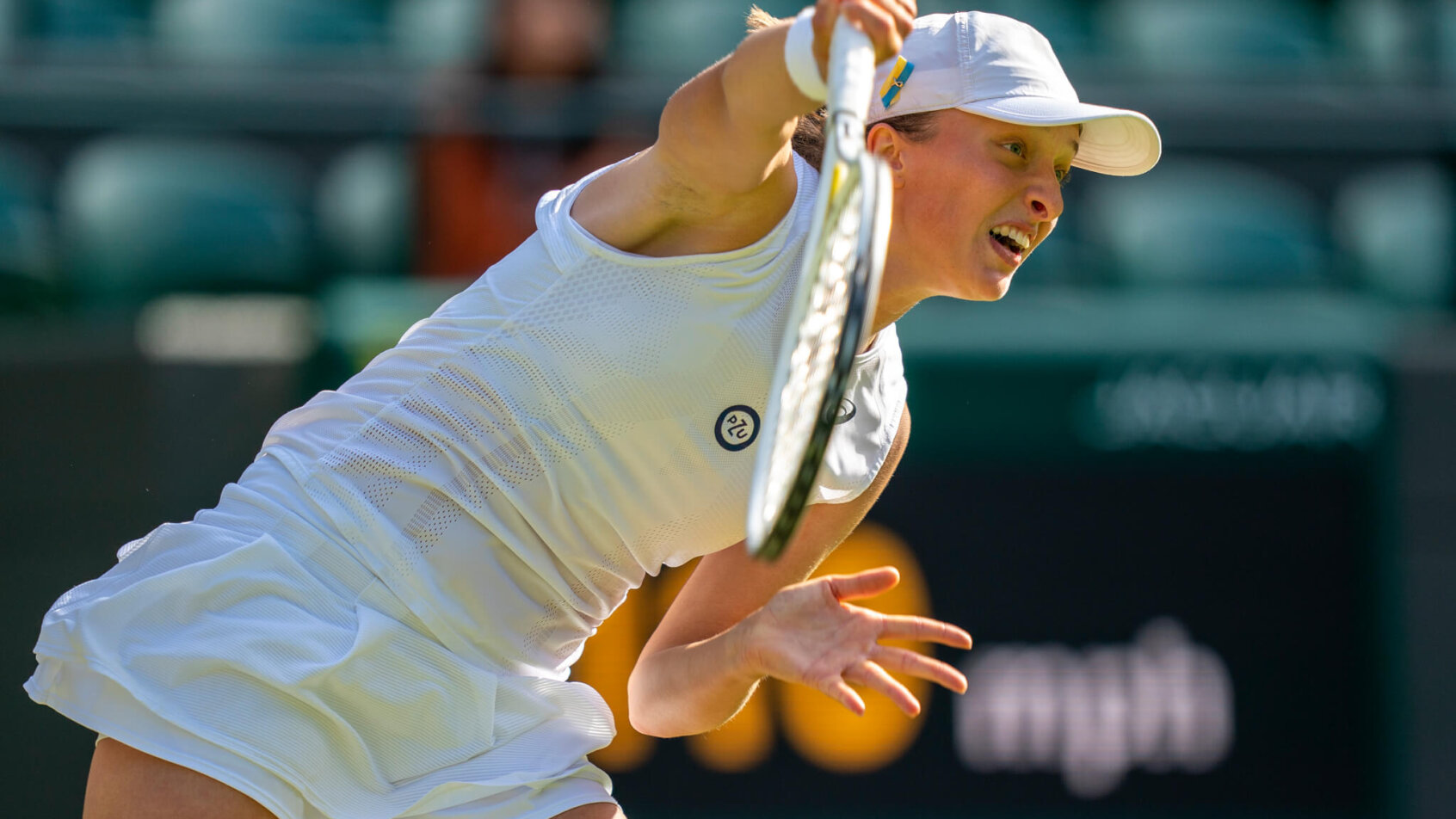 Iga Swiatek serving during a match at Wimbledon.