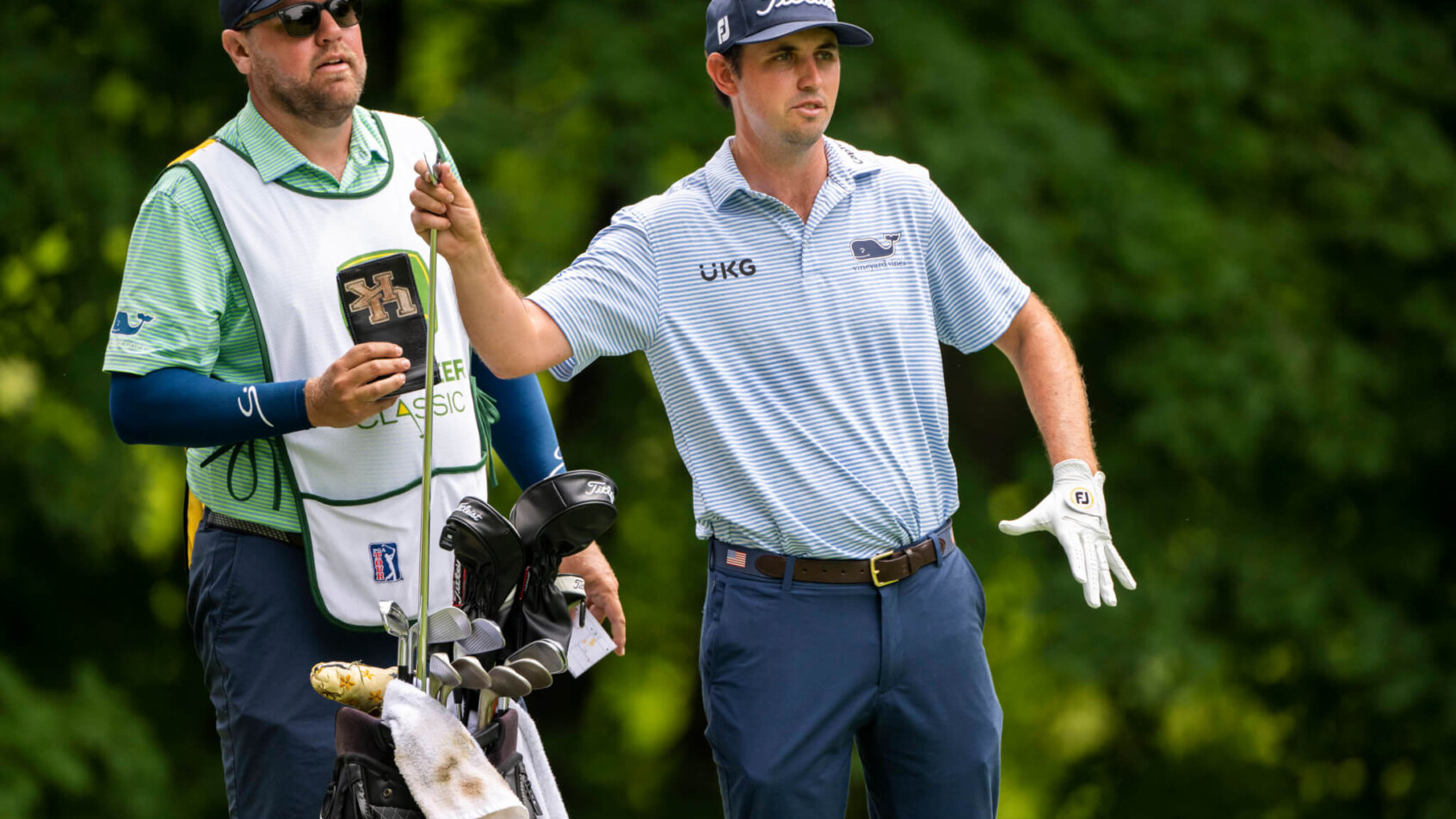 J.T. Poston grabs a club in the third round of the John Deere Classic